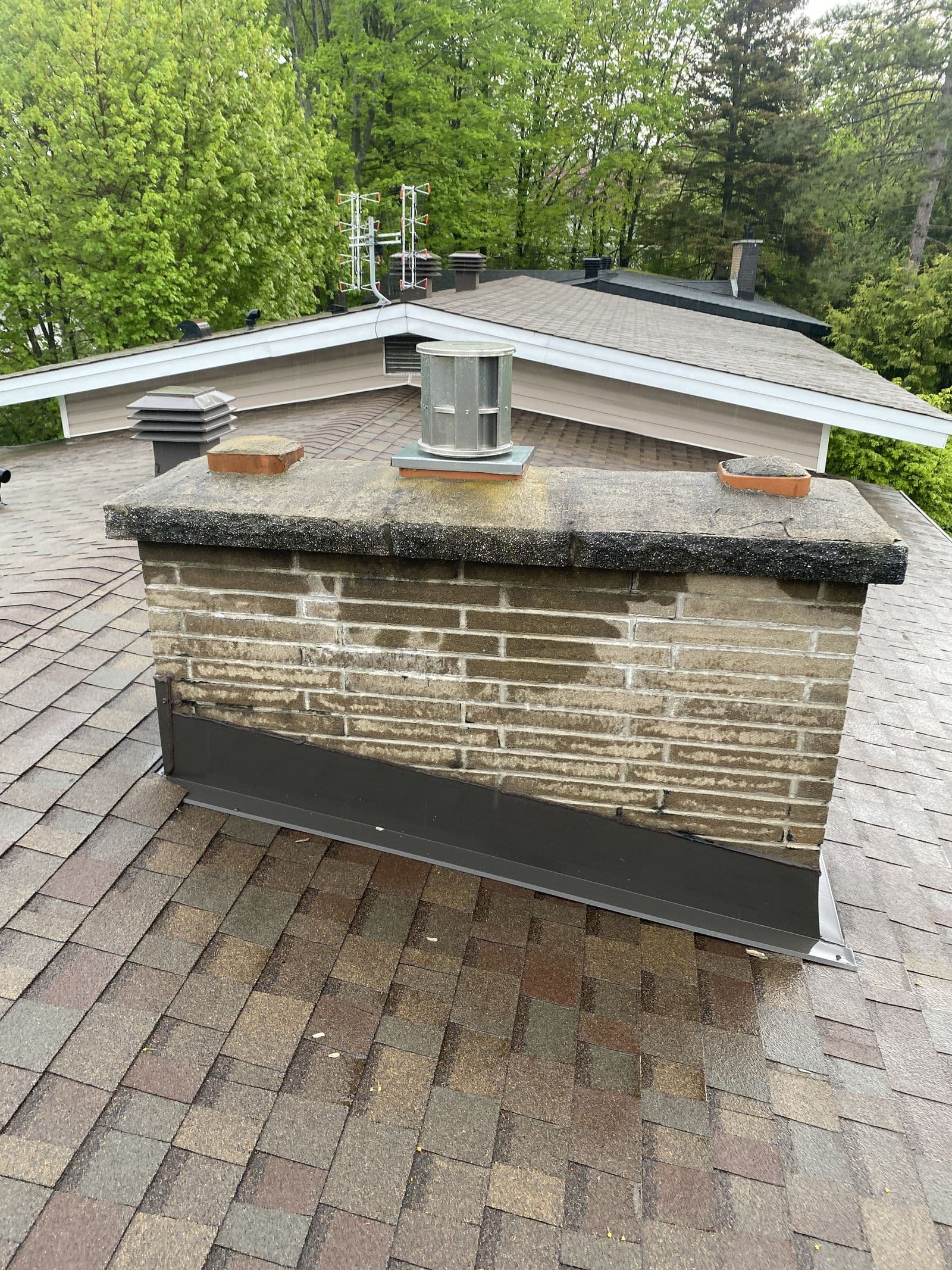 A weathered chimney with aging mortar, before cleaning and repair
