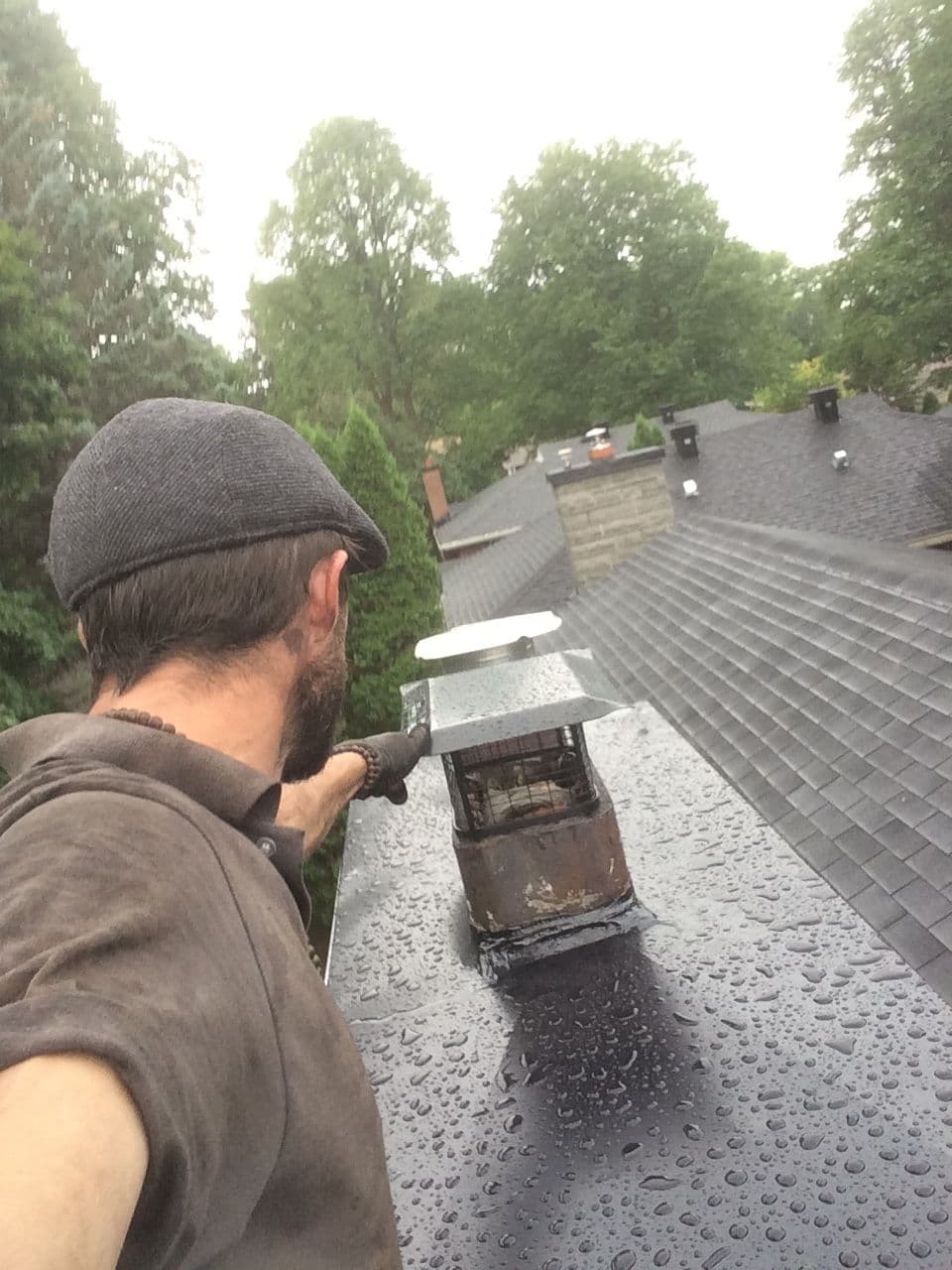 Jacob working on a rain cap in the rain