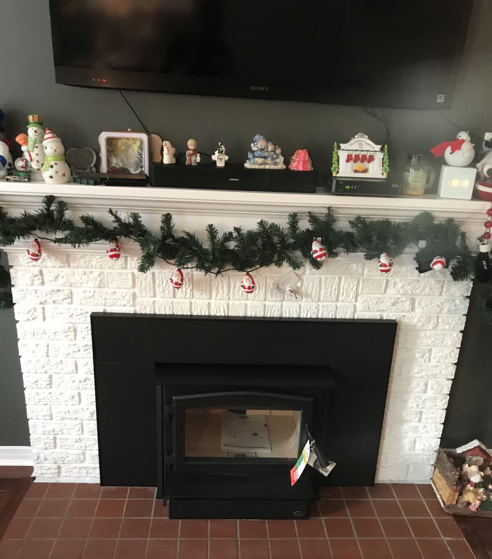 A wood-burning insert installed in a renovated fireplace