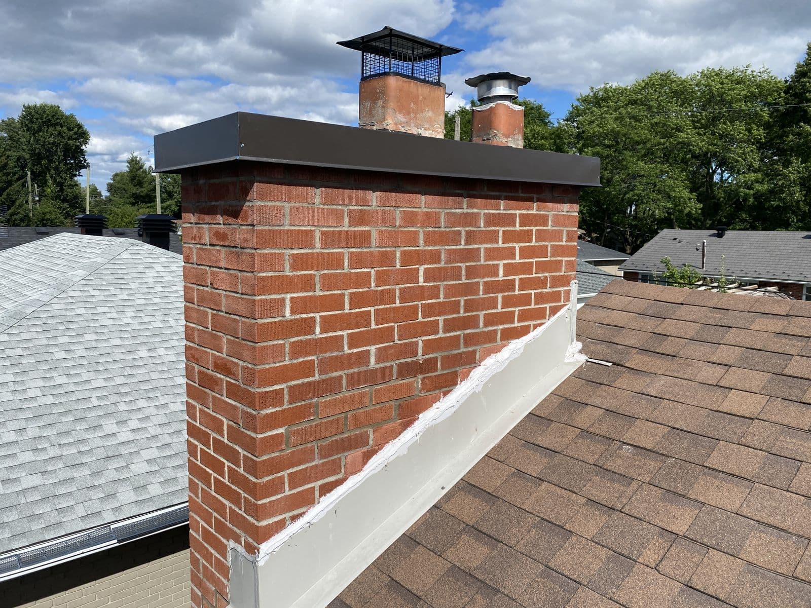 A new custom metal chase cover installed on the same chimney