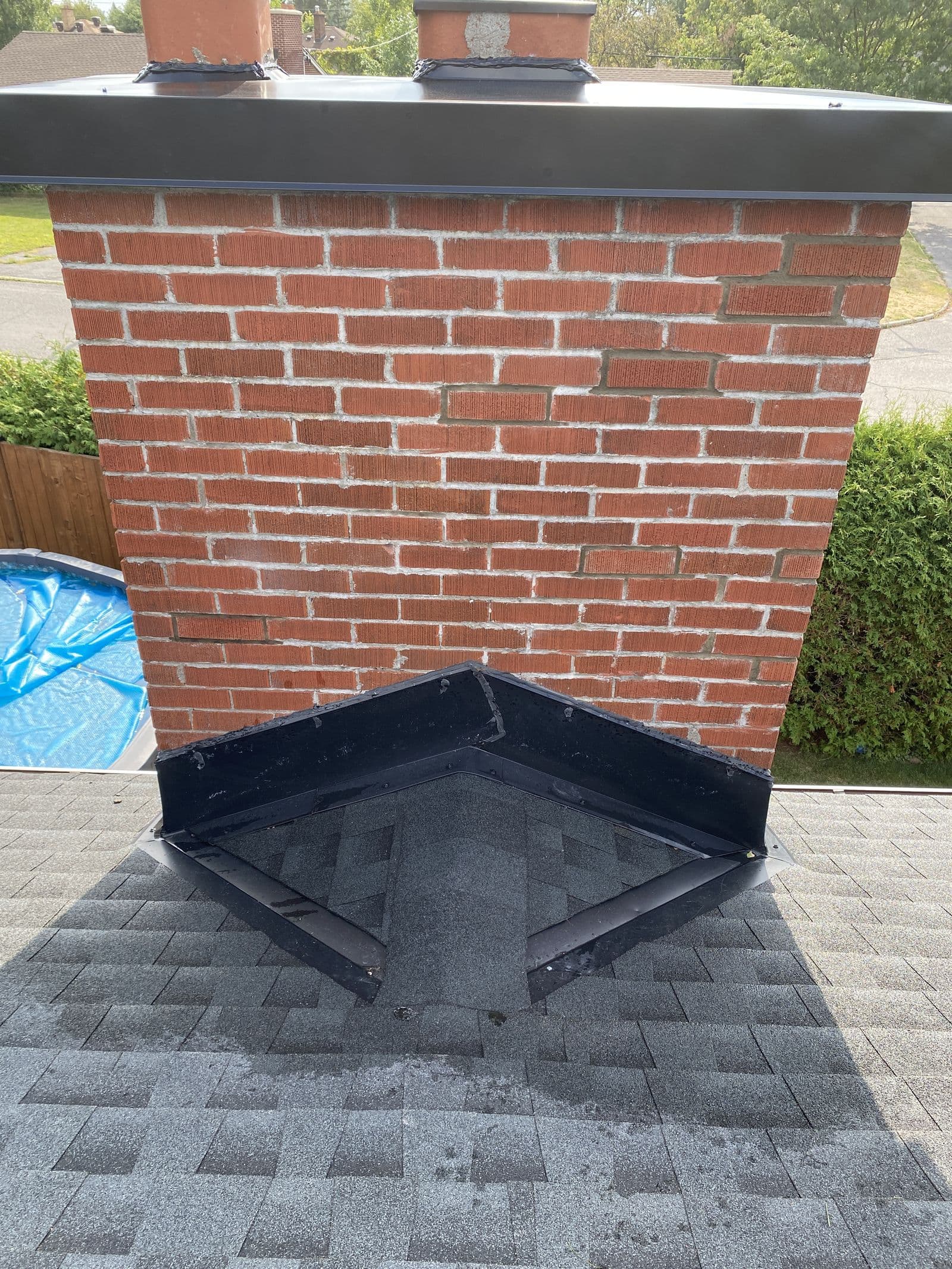 The same chimney after mortar repair and a new cricket flashing